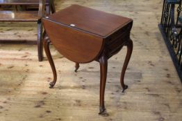 Mahogany drop leaf sewing table raised on four cabriole legs having two side drawers