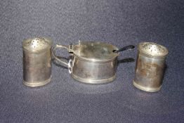 Silver three piece cruet set of oval form and with lidded mustard,