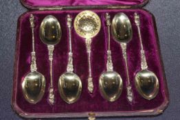 Cased set of silver apostle desert spoons and sifter,