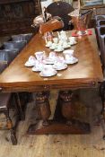 Large draw leaf oak refectory table raised on heavily carved twin columns to each end with