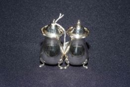 Pair of silver pepperettes,