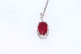 18 carat gold oval ruby and diamond halo cluster pendant on chain