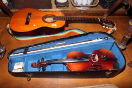 Cased violin and bow and Angelica acoustic guitar