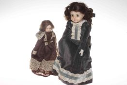 Two pottery faced dolls and rocking chair