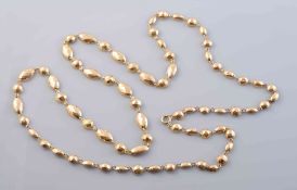 A GOLD COLOURED NECKLACE, formed of alternate circular and oval mounts with faceted detailing,