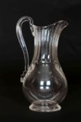 A LATE 18th CENTURY GLASS EWER, with long panelled neck, loop handle and baluster body.