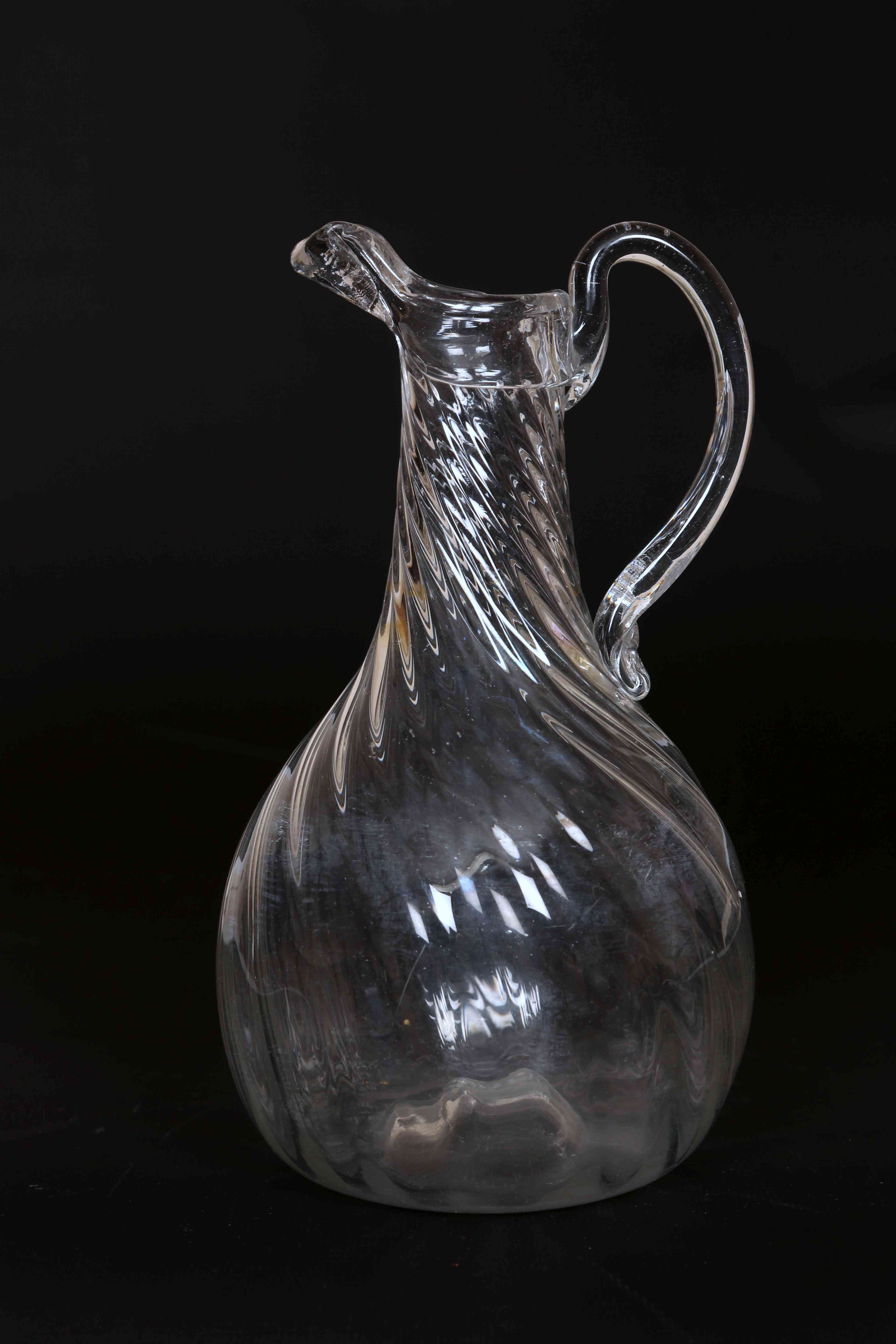 A WRYTHEN GLASS EWER, c. 1800, of baluster form, with loop handle.