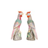 A PAIR OF CHINESE PORCELAIN MODELS OF PARROTS, polychrome painted, impressed and painted marks.