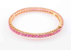 A BURMESE RUBY BANGLE, set to the entirety with fifty-four square mixed cut rubies,