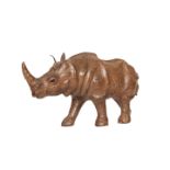 A LEATHER-COVERED WOODEN-FRAMED MODEL OF A RHINOCEROS, 20th century, modelled walking,