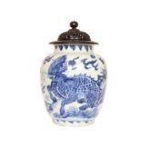 A CHINESE BLUE AND WHITE PORCELAIN JAR OF TRANSITIONAL TYPE, with pierced wooden cover,