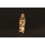A JAPANESE CARVED HORN NETSUKE, PROBABLY LATE 18th/EARLY 19th CENTURY, of a Dutchman,