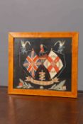AN EMBROIDERED WOOLWORK FOR THE BORDER REGIMENT, in a maple frame. Overall 48.5cm by 54.