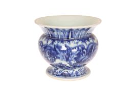 A CHINESE BLUE AND WHITE SPITTOON, the everted collar with stiff leaf decoration.