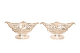 A PAIR OF LATE VICTORIAN SILVER PIERCED BASKETS, Charles Stuart Harris, London 1898, boat-shaped,