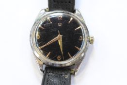 A VINTAGE OMEGA BLACK DIAL WRIST WATCH, with centre sweep seconds.