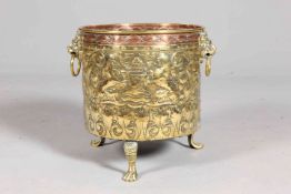 A HANDSOME BRASS AND COPPER PLANTER, repousse with lions, mounted figure and foliage. 44.