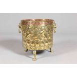 A HANDSOME BRASS AND COPPER PLANTER, repousse with lions, mounted figure and foliage. 44.