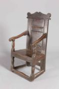 A 17TH CENTURY OAK WAINSCOT CHAIR, with yoked crest and two-panel back.