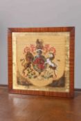 A 19TH CENTURY WOOLWORK AND BEADWORK PANEL, depicting the Royal Coat of Arms, in a mahogany frame.