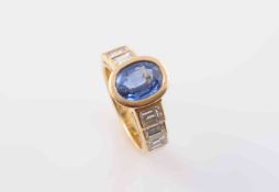 A CONTEMPORARY SAPPHIRE AND DIAMOND RING, the oval cut collet set sapphire in a heavy oval mount,