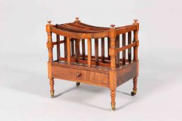 A 19TH CENTURY ROSEWOOD CANTERBURY, with drawer and short turned legs, moving on castors. 47cm wide.