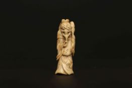 A JAPANESE IVORY NETSUKE, PROBABLY LATE 18th/EARLY 19th CENTURY, of a standing sennin.