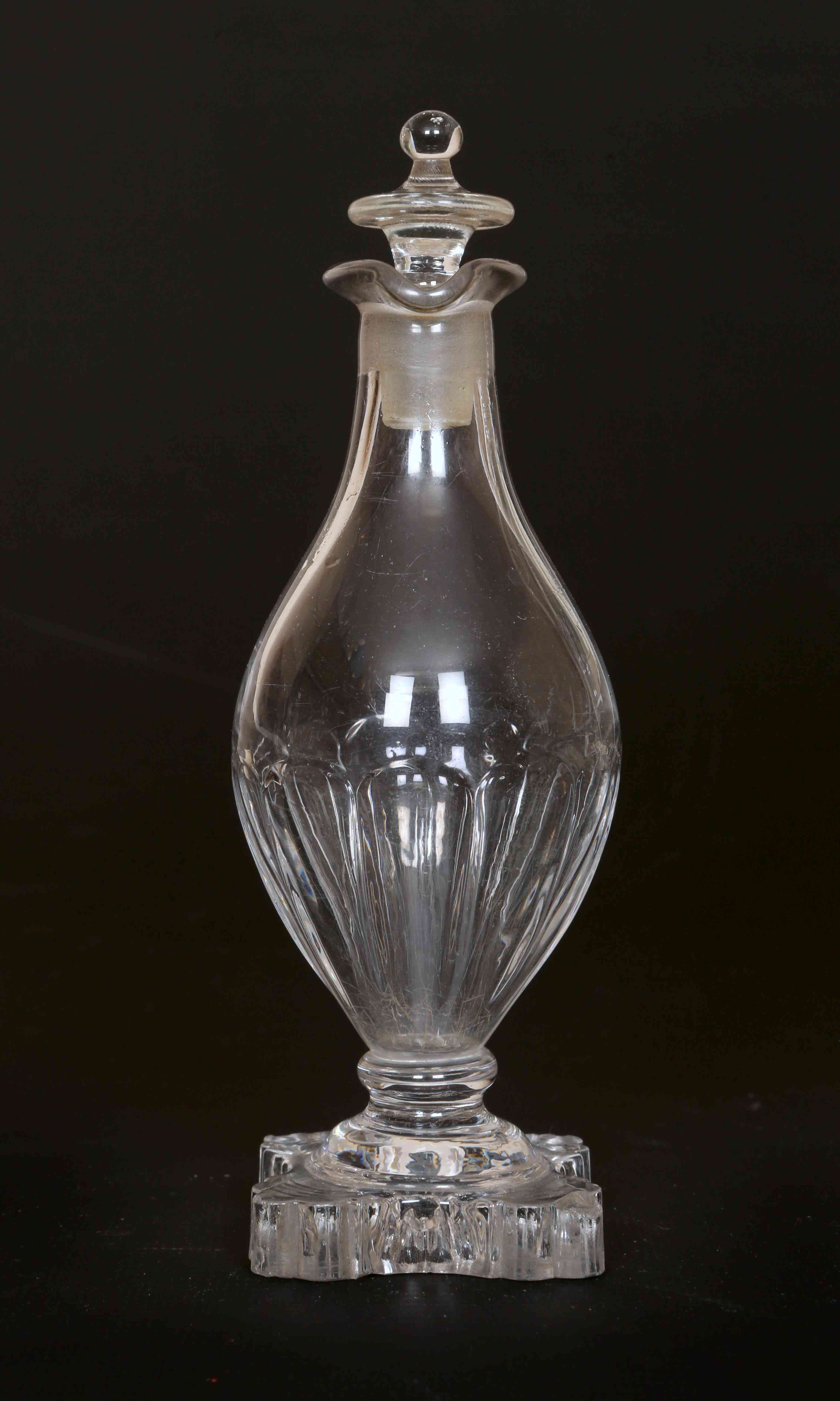 AN EARLY 19th CENTURY GLASS VINEGAR BOTTLE, of baluster shape, with flattened urn stopper,