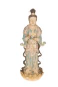 A LARGE CHINESE EARTHENWARE FIGURE OF GUANYIN, modelled in robes and standing on a leaf clad base.