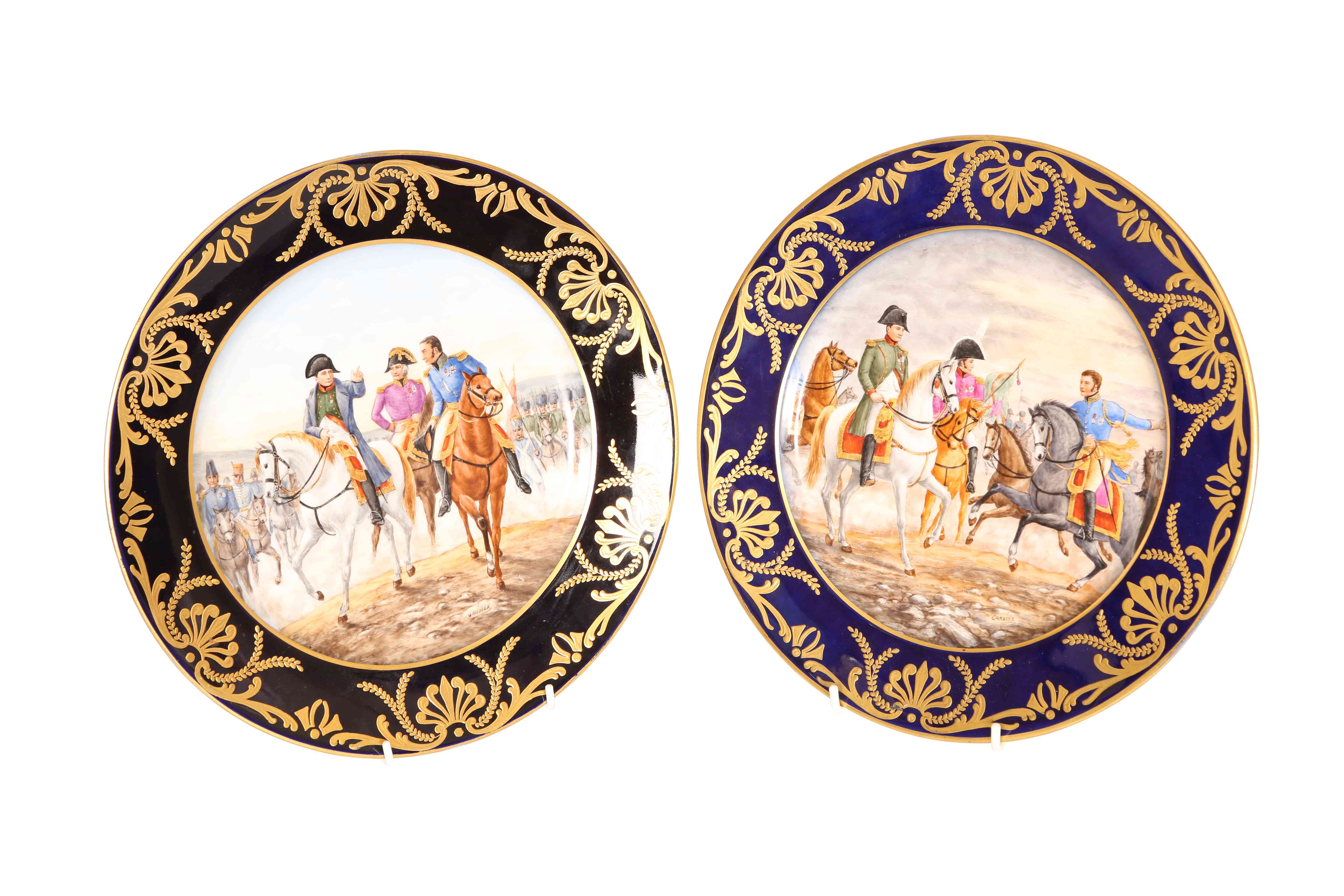 A NEAR PAIR OF CONTINENTAL PAINTED AND GILDED PORCELAIN PLATES, each signed GARNIER,