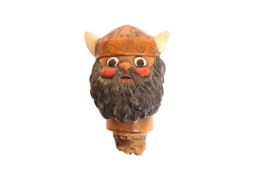 A CARVED AND PAINTED WOODEN FLAGON CORK, modelled as a Viking's head.