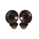 A PAIR OF CHINESE BLACK GLASS BOWLS ON STANDS, each bowl with everted rim and plain foot,