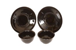 A PAIR OF CHINESE BLACK GLASS BOWLS ON STANDS, each bowl with everted rim and plain foot,