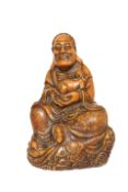 A CHINESE SOAPSTONE FIGURE OF A SEATED LOHAN, carved seated and holding a Buddhistic lion pup.