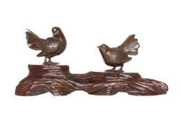 A JAPANESE BRONZE GROUP OF BIRDS, the two birds standing on a naturalistically carved wooden base,