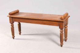 AN OAK WINDOW SEAT IN 19TH CENTURY STYLE, raised on reeded legs.