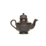 A SMALL 18th CENTURY POTTERY TEAPOT, OF JACKFIELD TYPE, with lustrous black glaze,