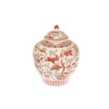 A CHINESE JAR AND COVER, red and green painted with deer and trees,