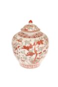 A CHINESE JAR AND COVER, red and green painted with deer and trees,