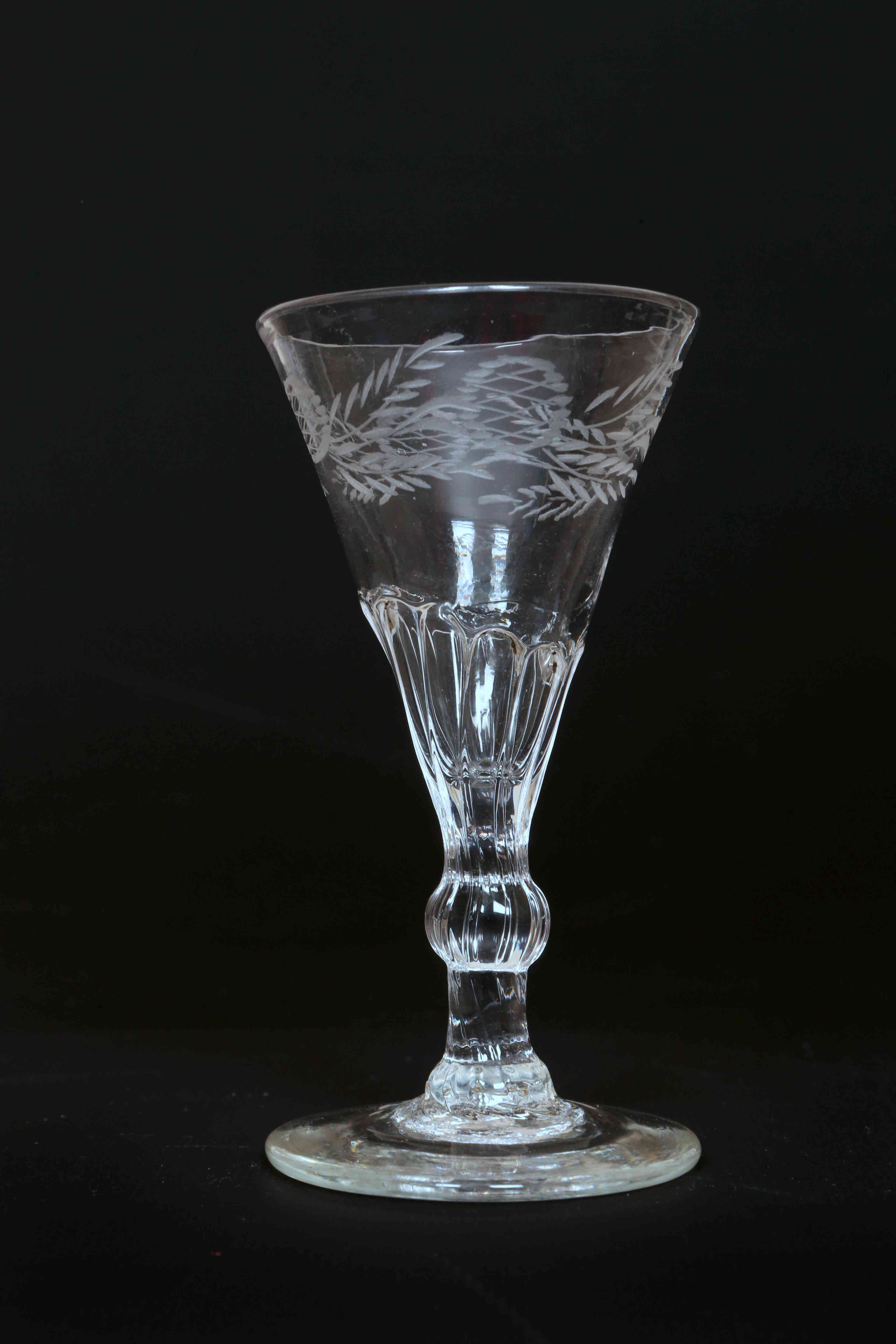 A LATE 18th CENTURY WINE GLASS, the trumpet bowl part panelled,