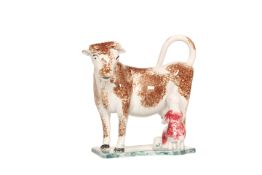 A PRATT TYPE COW AND MILKMAID CREAMER, probably North-East region, sponged in brown green and pink,