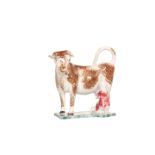 A PRATT TYPE COW AND MILKMAID CREAMER, probably North-East region, sponged in brown green and pink,