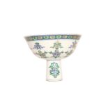 A CHINESE PORCELAIN STEM CUP, painted with objects and sprigs of foliage,