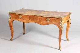 A LOUIS XV STYLE BRASS MOUNTED AND LEATHER INSET BUREAU PLAT, of shaped outline,