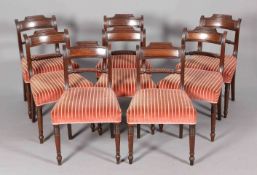 A SET OF EIGHT LATE REGENCY ROSEWOOD DINING CHAIRS, each with brass strung tablet crest,