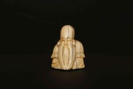 A JAPANESE IVORY NETSUKE, MEIJI PERIOD, of a bearded sage.