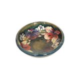 A MOORCROFT POTTERY ORCHID PATTERN BOWL, tubelined and painted against a shaded blue/green ground,