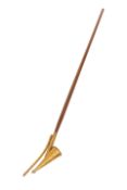 A BRASS LONG-ARM CANDLE SNUFFER, with conical snuffer and taper light, on a wooden pole.