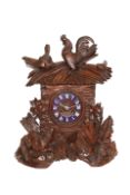 A BLACK FOREST MANTEL CLOCK, 19TH CENTURY, the case elaborately carved with cockerel surmount,