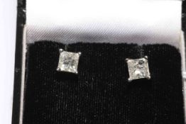 Pair of 14 carat white gold princess cut diamond solitaire ear studs,